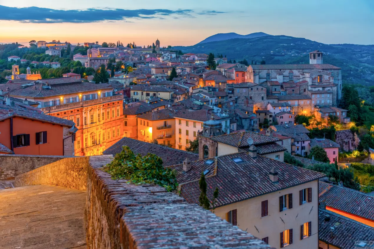 Perugia historic centre at golden hour with terracotta rooftops and hills
